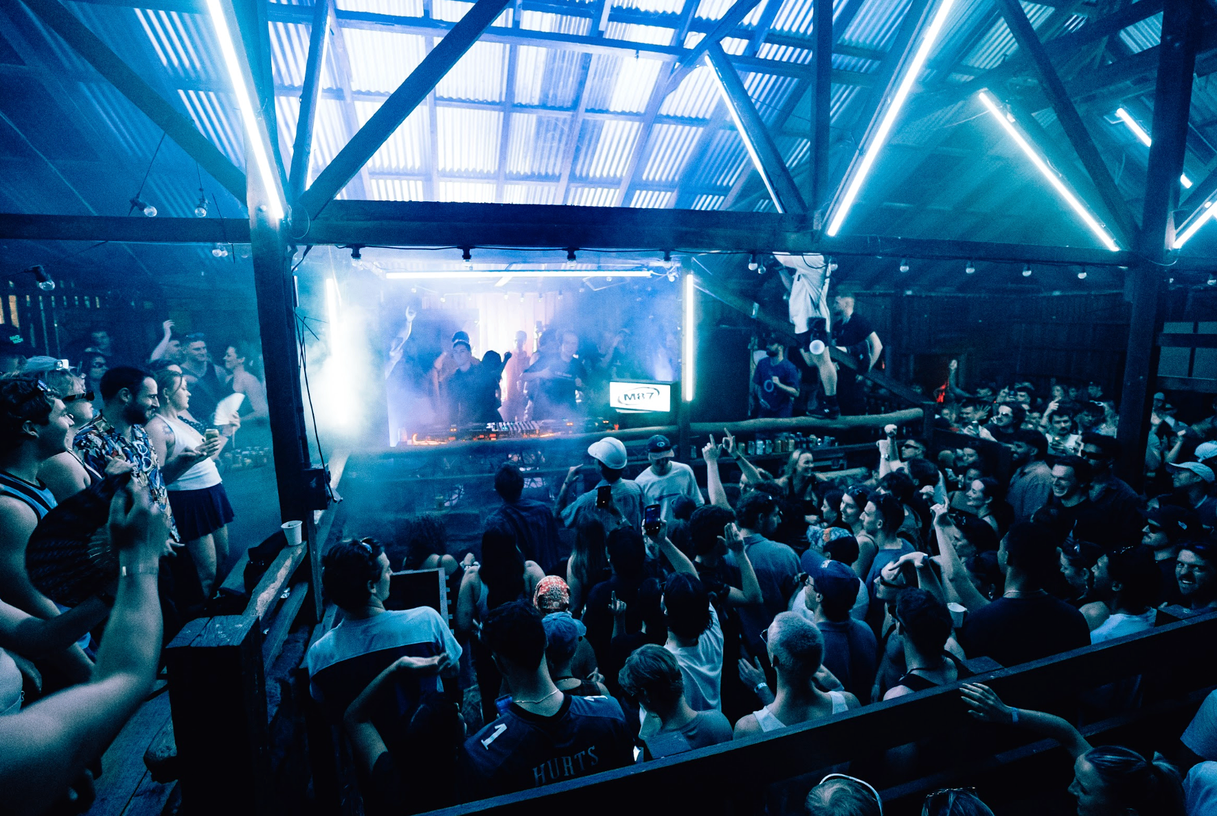 M87 shed party in blue neon